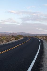 Empty road against sky