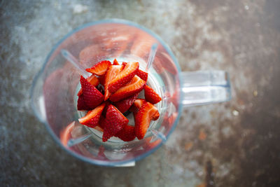 High angle view of strawberries on glass table