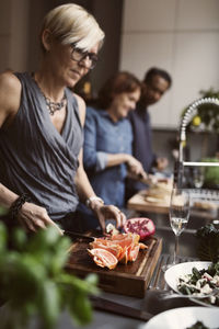 Woman with vegetables standing on glass