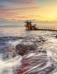 Sunset at blacrock diving tower on salthill beach in galway city, ireland