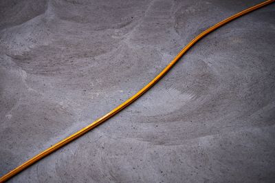 High angle view of yellow umbrella on road