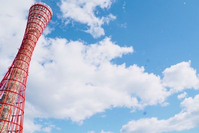 Low angle view of ferris wheel against cloudy sky