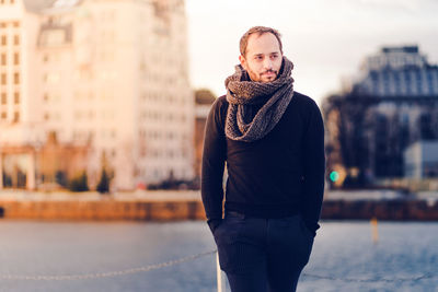 Man wearing scarf standing outdoors