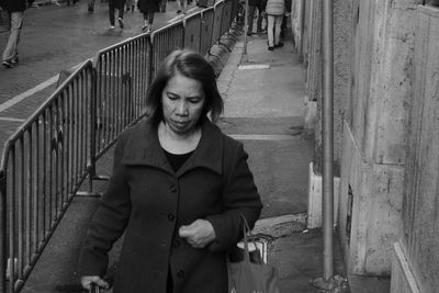 Portrait of smiling woman standing on staircase