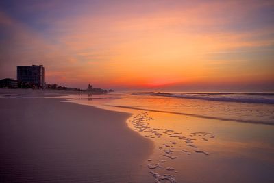 View of calm beach at dusk