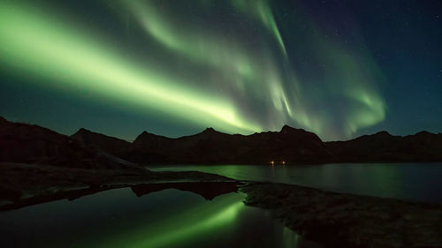 Scenic view of lake against sky at night