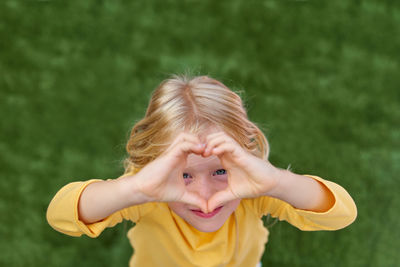 Portrait of girl playing with arms raised