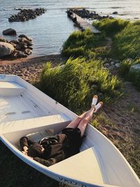High angle view of man sitting on lake