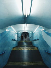 Man in illuminated tunnel