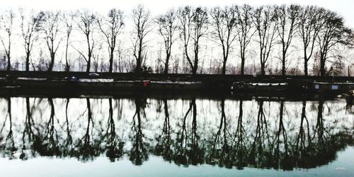 Scenic view of lake against sky during winter