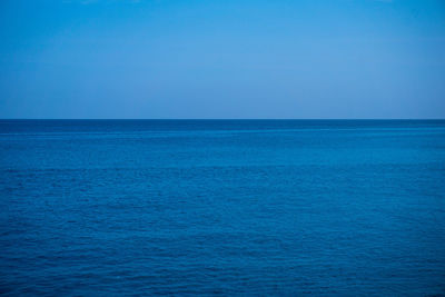 Scenic view of blue sea against clear sky