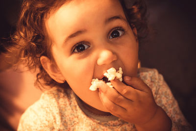 Close-up portrait of cute boy eating food