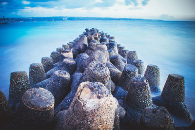 Panoramic view of pebbles on beach against sky