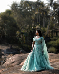 Young woman standing on rock