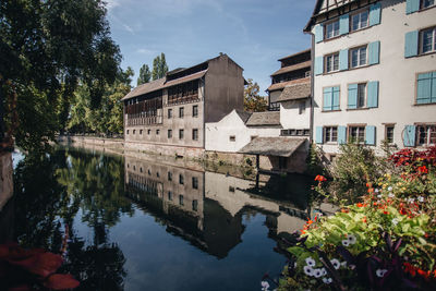 Reflection of buildings and trees in lake