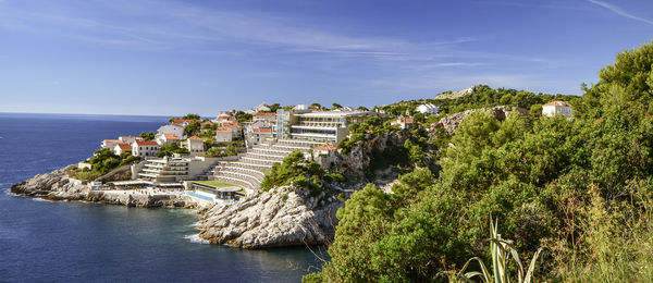 High angle view of buildings by sea against sky