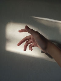 Close-up of hand touching wall