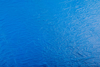 Full frame flat background and texture of crumpled blue plastic film