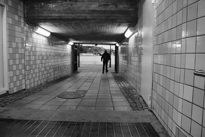 Man in illuminated tunnel