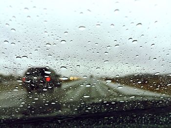 Close-up of rain drops on road