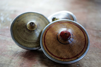 Close-up of spinning tops on wooden table