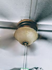 Low angle view of electric lamp hanging on ceiling