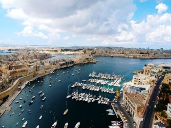 High angle view of harbor against cloudy sky