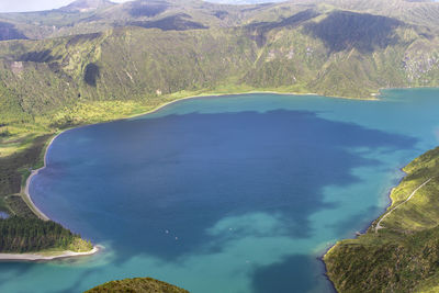 High angle view of volcanic mountain by sea