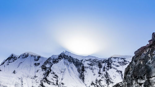 Scenic view of mountains against blue sky