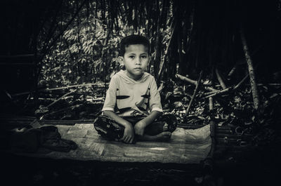 Portrait of boy sitting outdoors