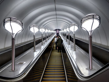 Low angle view of people on escalator