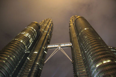 Low angle view of illuminated buildings against sky at night