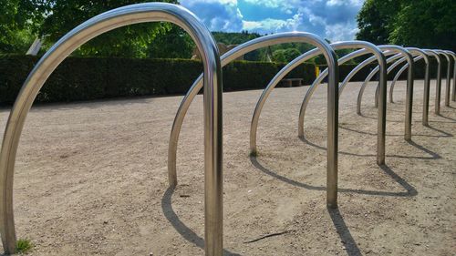 Bicycle racks at park on sunny day