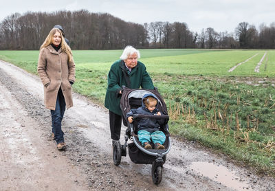 Family walking on dirt road