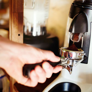 Close-up of hand holding coffee cup