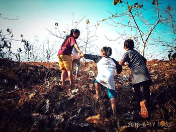 Full length of children on land against sky