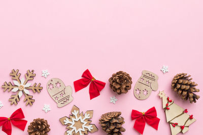 Directly above shot of christmas decorations on pink background