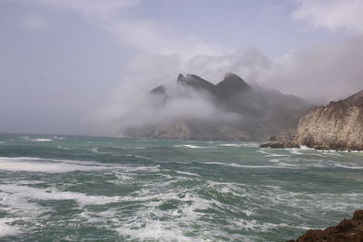 Scenic view of sea against cloudy sky