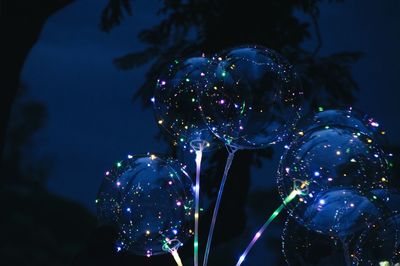 Low angle view of bubbles in water at night