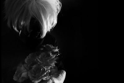 Close-up of baby girl in black background