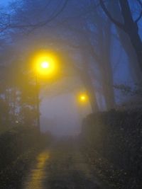 Close-up of illuminated lights against sky at night