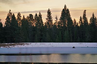 Scenic view of lake against sky at sunset