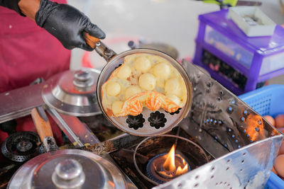 Cropped hand of person preparing food