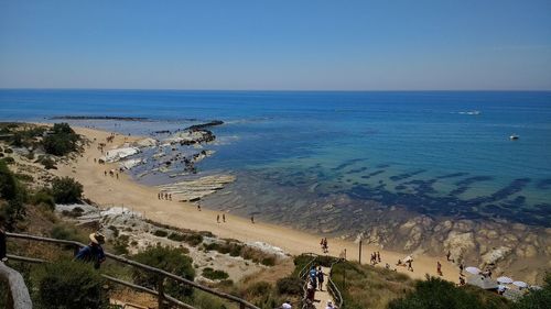 High angle view of people walking on beach