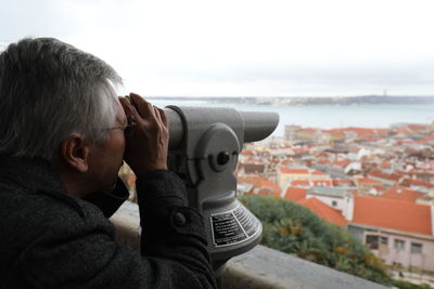 Mature man looking through binoculars