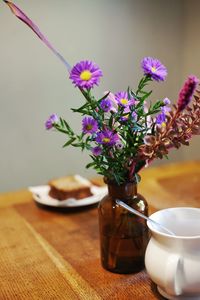 Close-up of purple flowers in vase on table