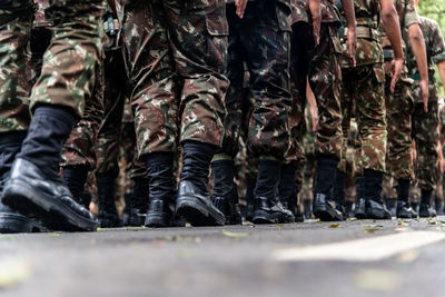  low view of the legs of brazilian army soldiers marching through the streets 