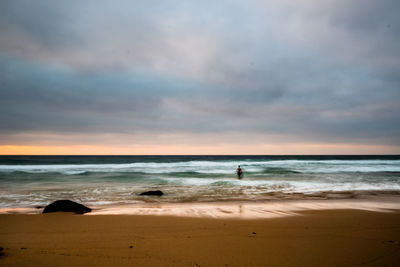 Scenic view of beach against sky during sunset