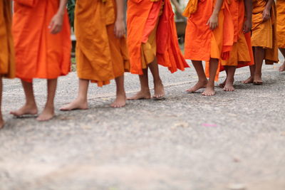 Low section of women standing on street