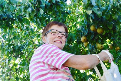 Portrait of woman with fruits and plants